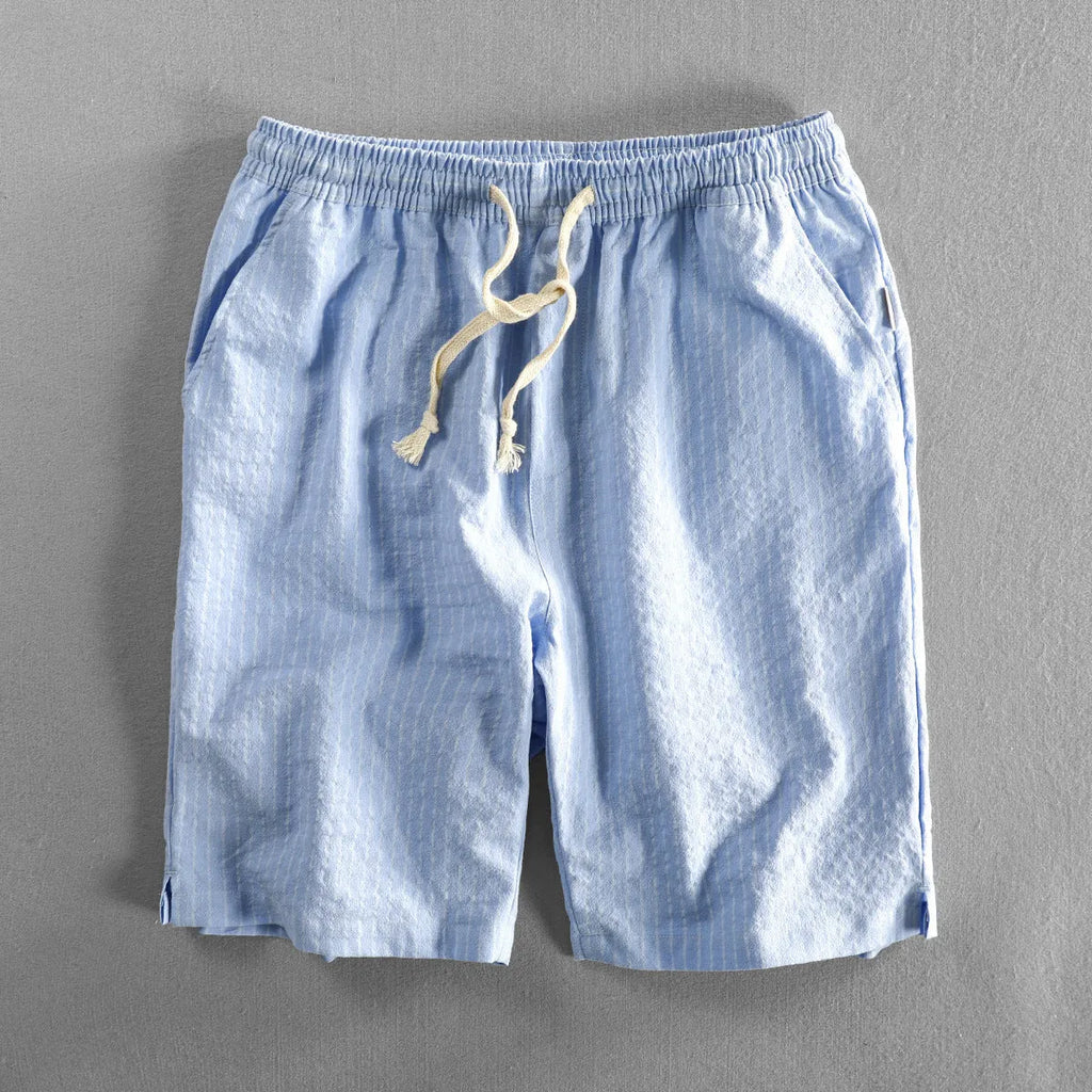 Men's striped casual shorts in cotton with elastic waist, showing loose straight fit and colour options.