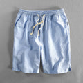 Men's striped casual shorts in cotton with elastic waist, showing loose straight fit and colour options.