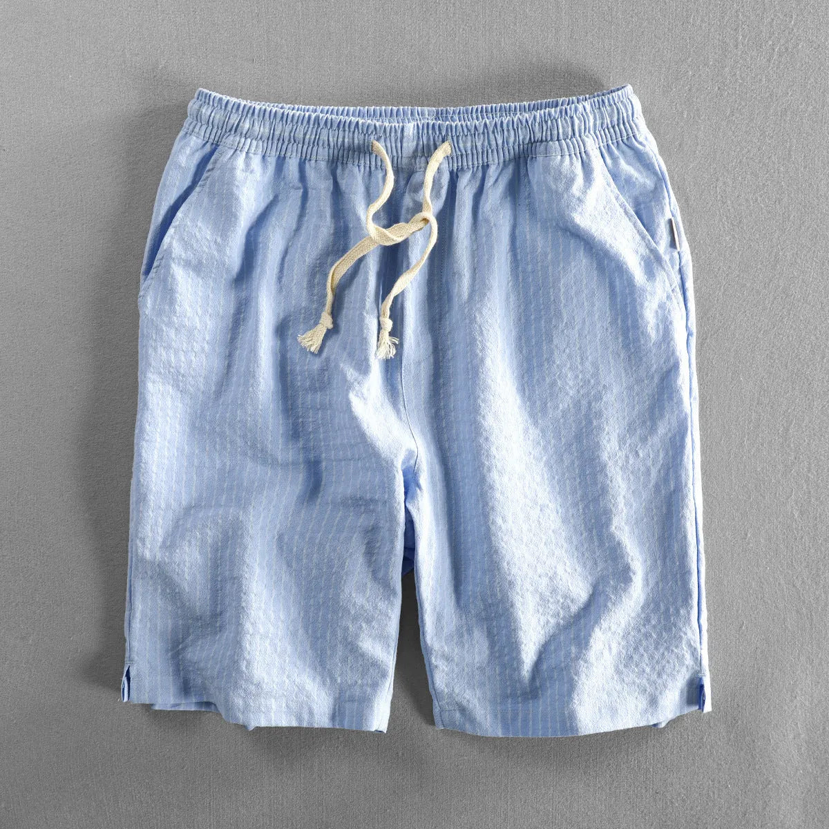 Men's striped casual shorts in cotton with elastic waist, showing loose straight fit and colour options.