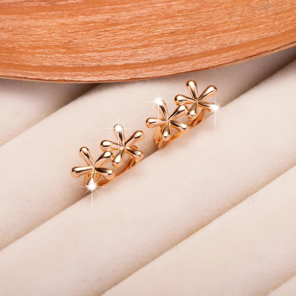 Rose gold coloured circular stud earrings with a detailed waterdrop floral design.