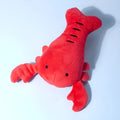 Red lobster shaped squeaky dog toy with soft plush material measuring 12.5cm length