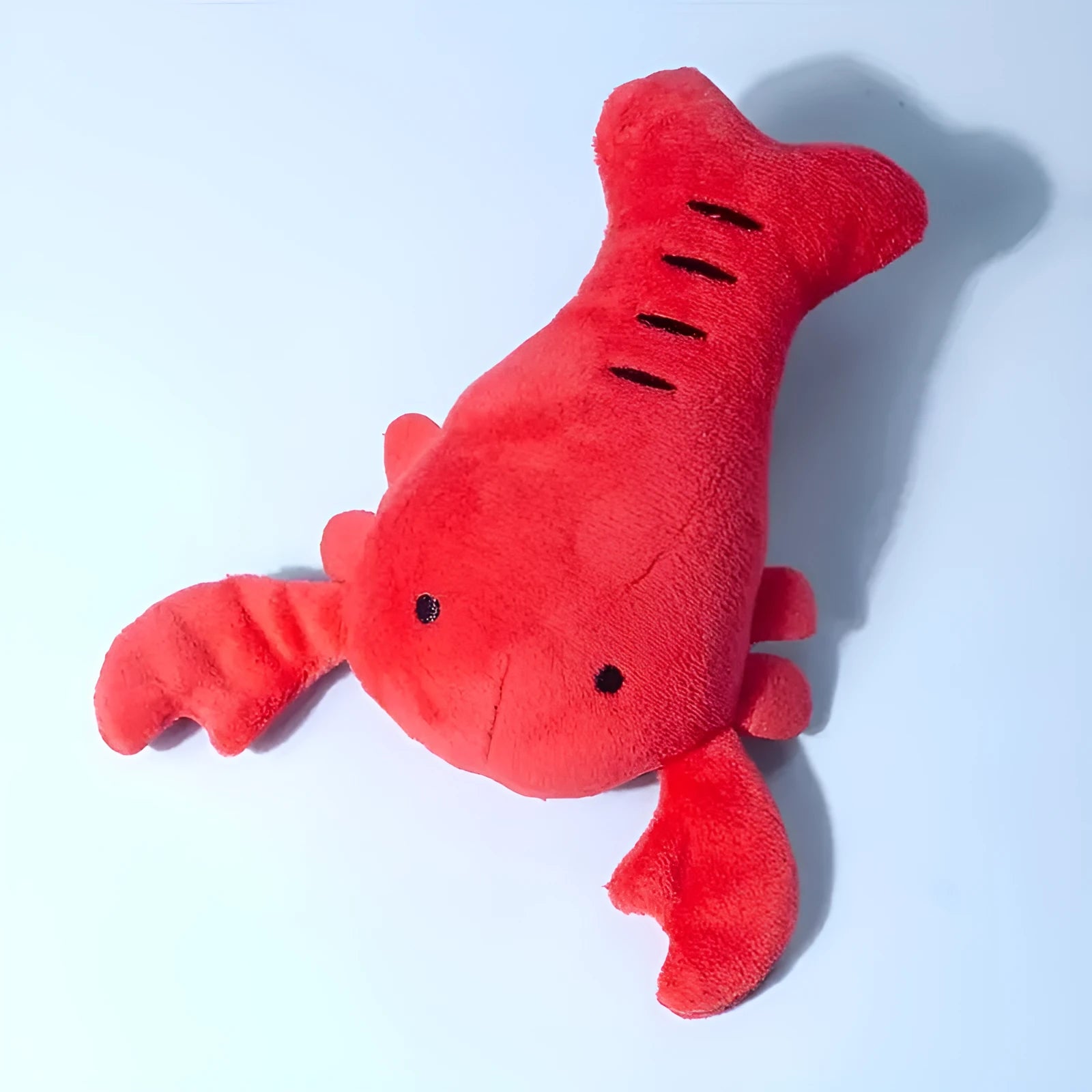 Red lobster shaped squeaky dog toy with soft plush material measuring 12.5cm length