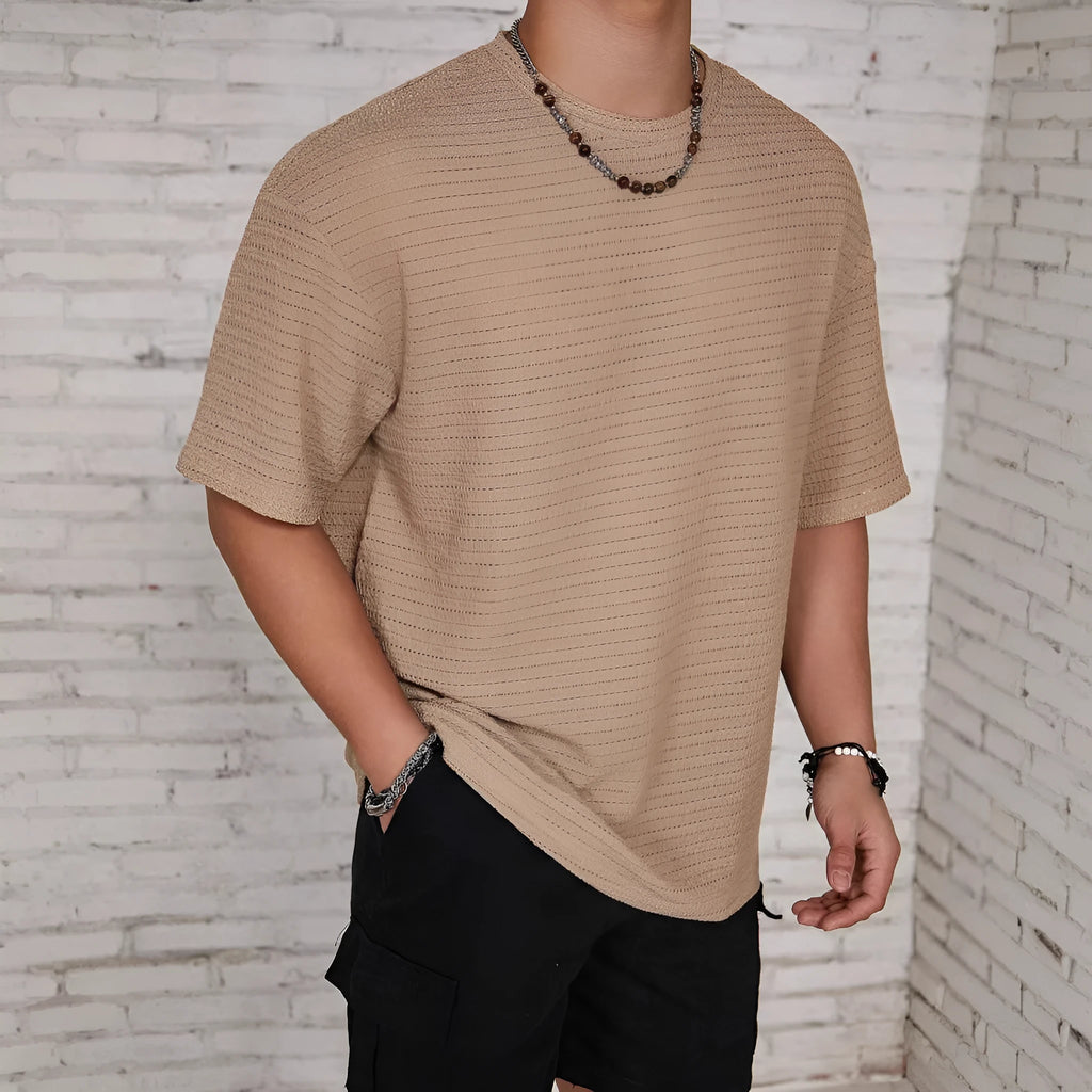 Men's slim-fit loose t-shirt in light blue solid colour, showing round neck and short sleeves.