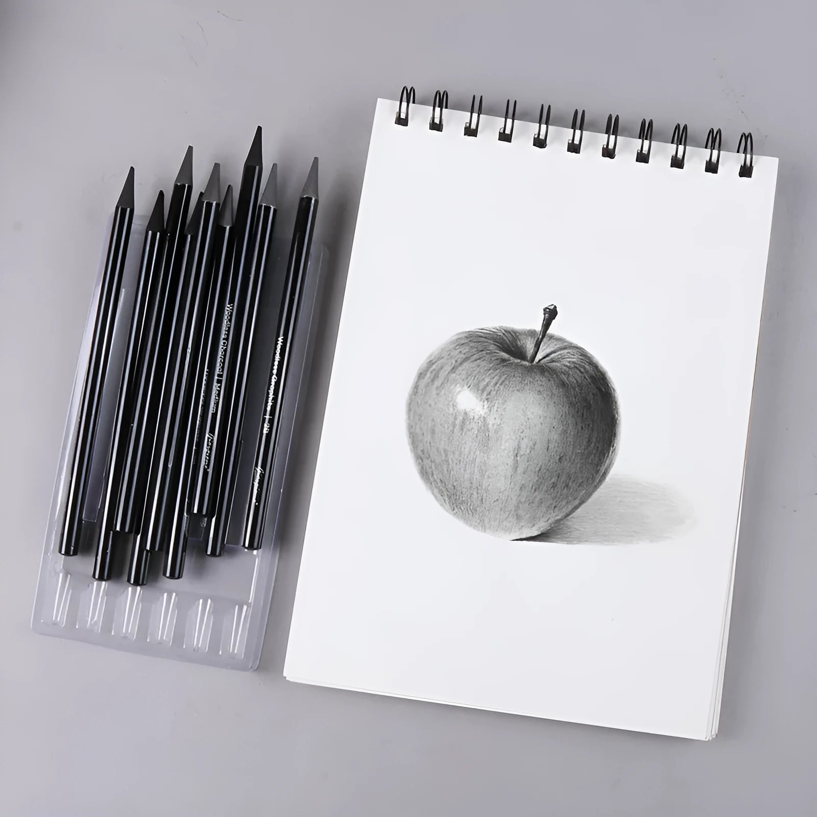 Graphite and carbonized wooden drawing pencils with solid lead cores on suction card packaging