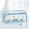 Transparent double-layer pencil case showing interior compartments in blue colour variant