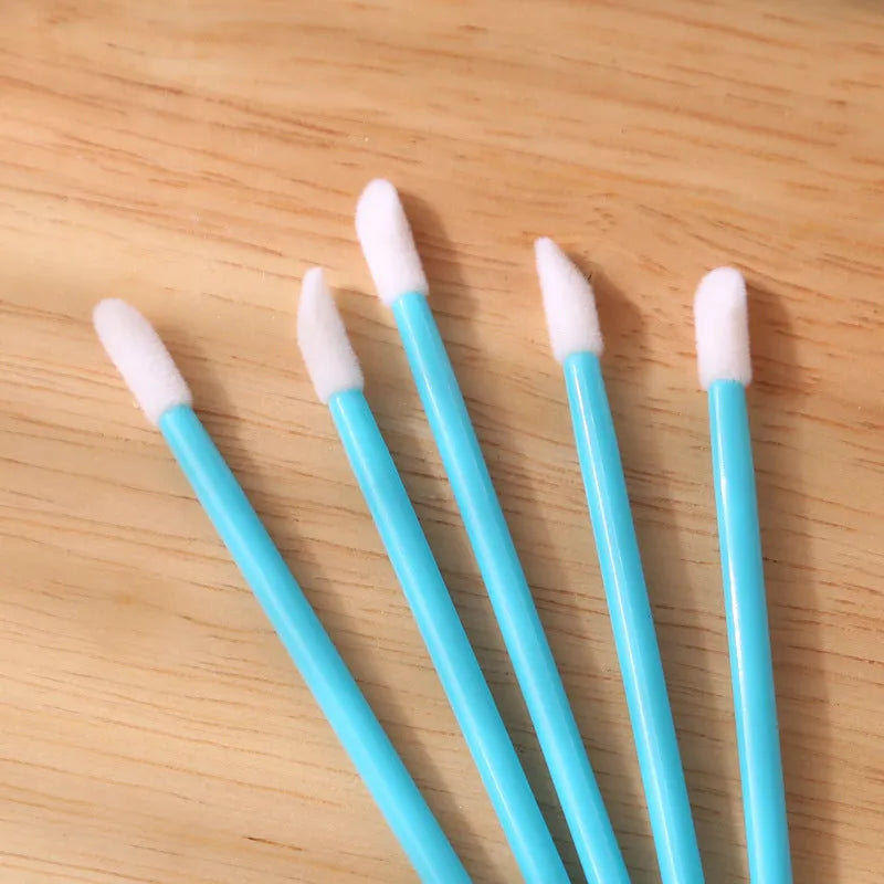 Disposable lip brushes with black handles and flocked tips in bulk packaging for lipstick and gloss application