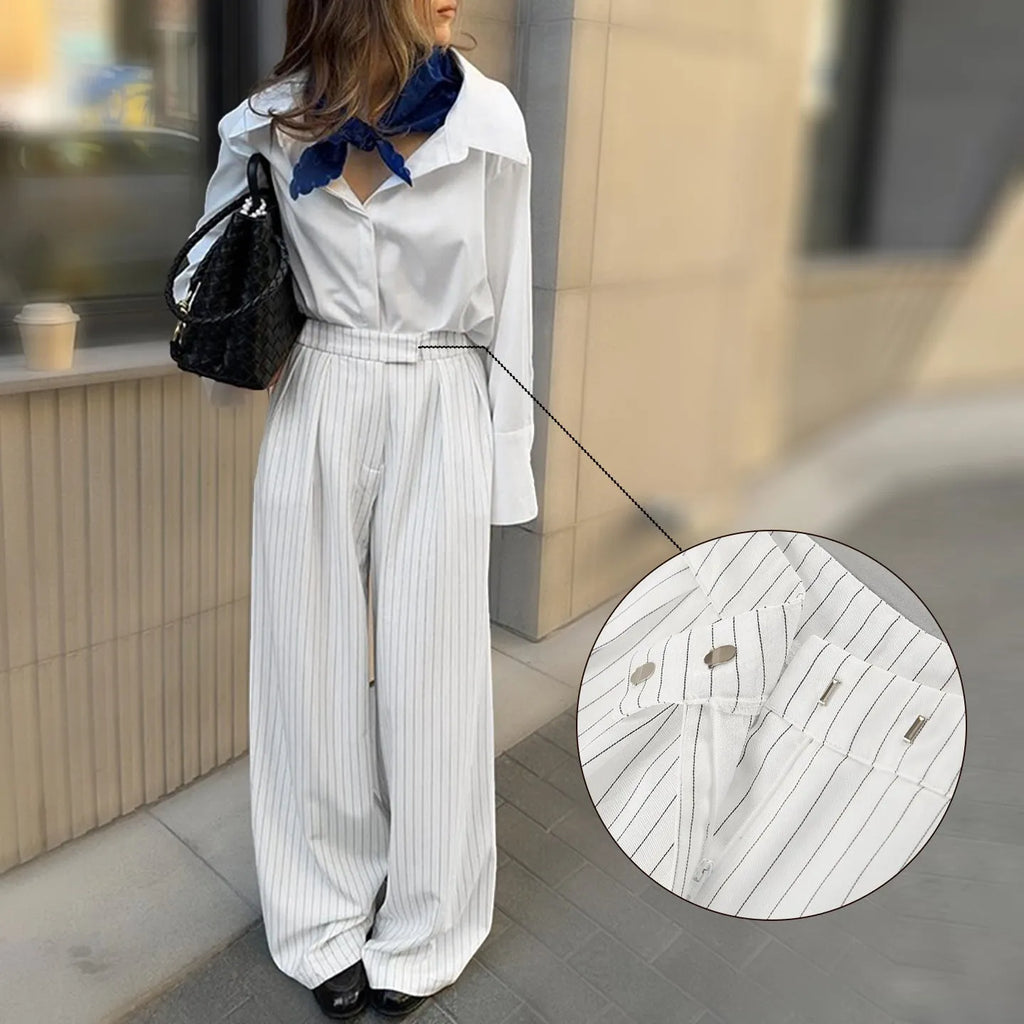 White striped wide-leg loose fit trousers with zipper front on a hanger