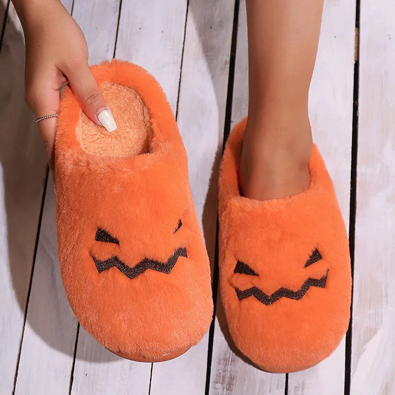 Orange Halloween pumpkin design plush slippers with a non-slip sole.