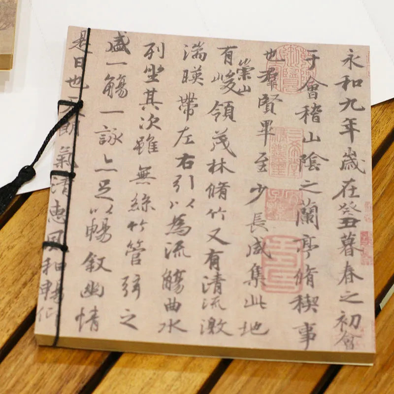 A5 antique wire-bound notebook with retro painting cover, thread binding, and black tassels.