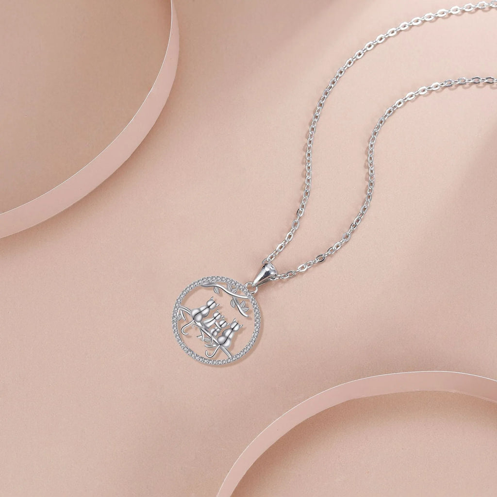 Copper Four Kitten Necklace with cat charm pendant on a cross chain for women.