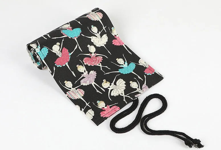 Canvas pencil case roll with ballet girl print, shown unrolled to display multiple pencil pockets.