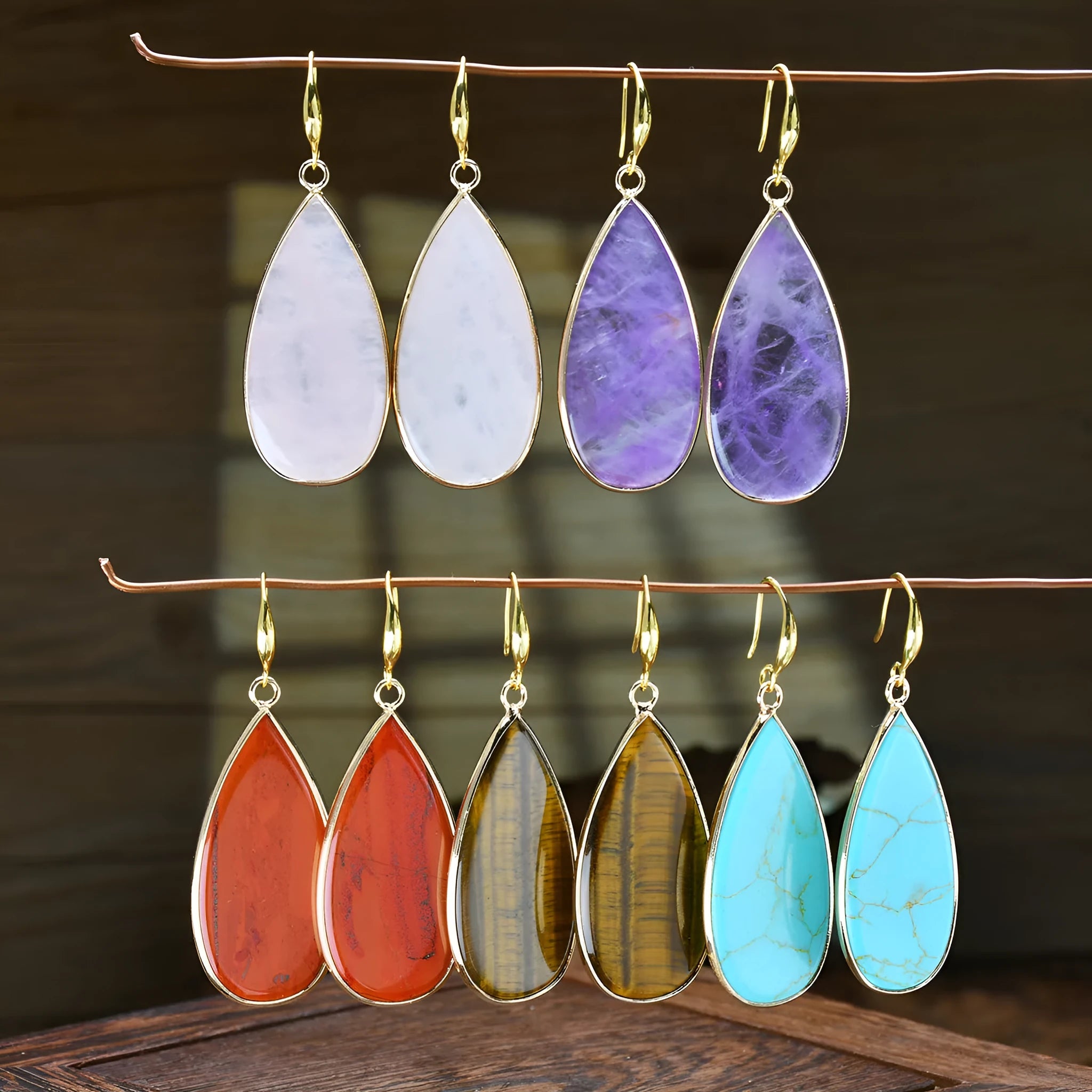 Vintage long drop earrings made from stone with a water droplet texture, shown in Tigereye colour.