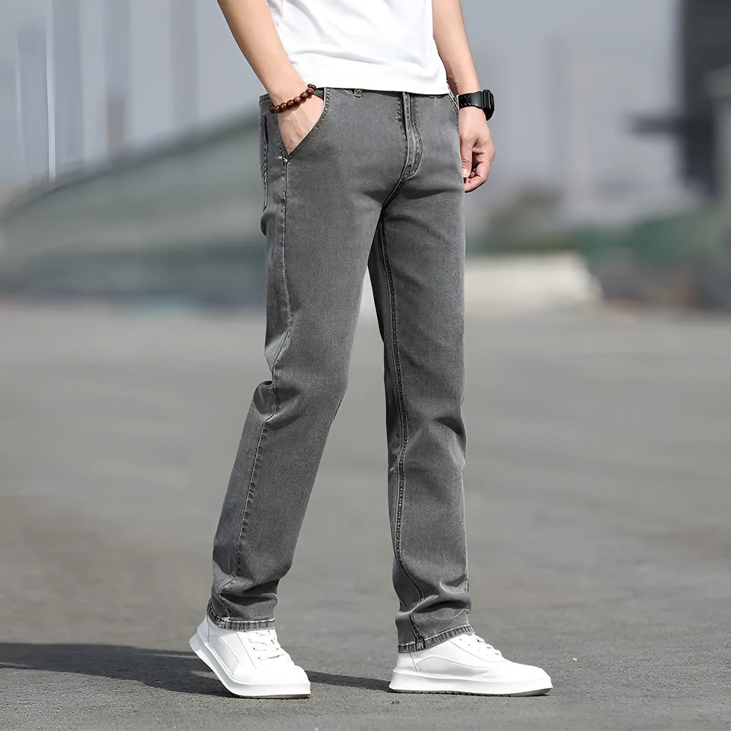 Men's smoky gray straight leg jeans with low waist and zipper fly closure