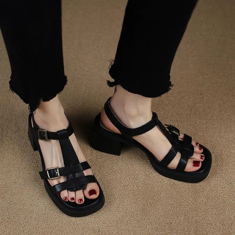 Black retro women's sandals with a T-shaped buckle, open square toe, and a chunky platform heel.