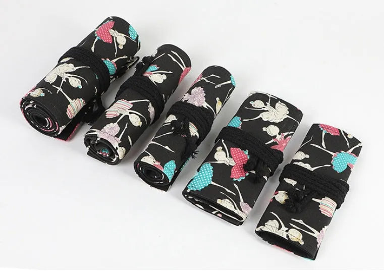 Canvas pencil case roll with ballet girl print, shown unrolled to display multiple pencil pockets.