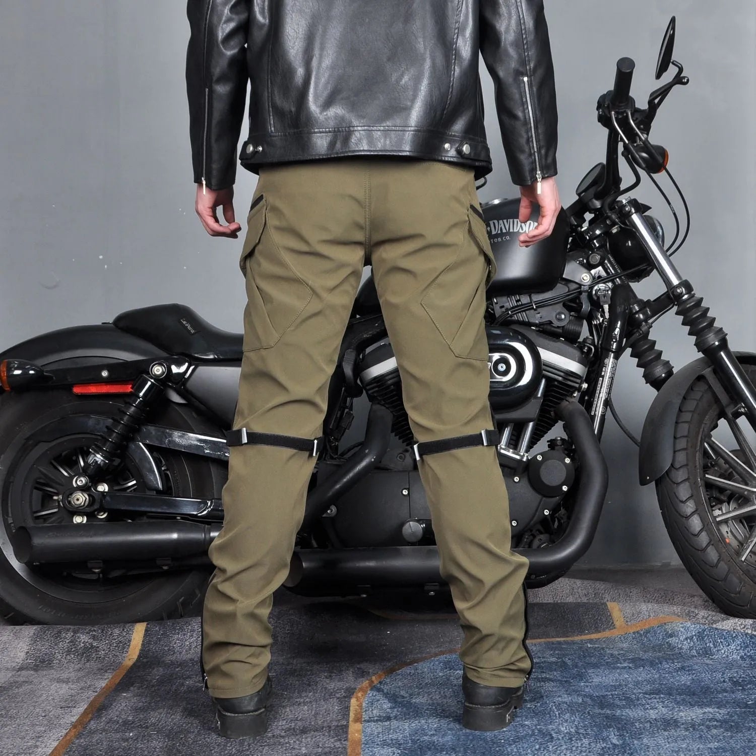 Men's black waterproof motorcycle cycling trousers with protective gear on a mannequin