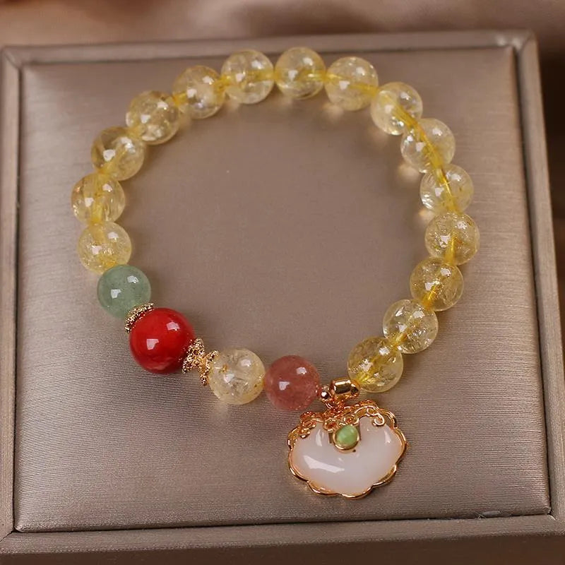 Women's alloy bracelet with a yellow citrine jade ruyi pendant on a white background.