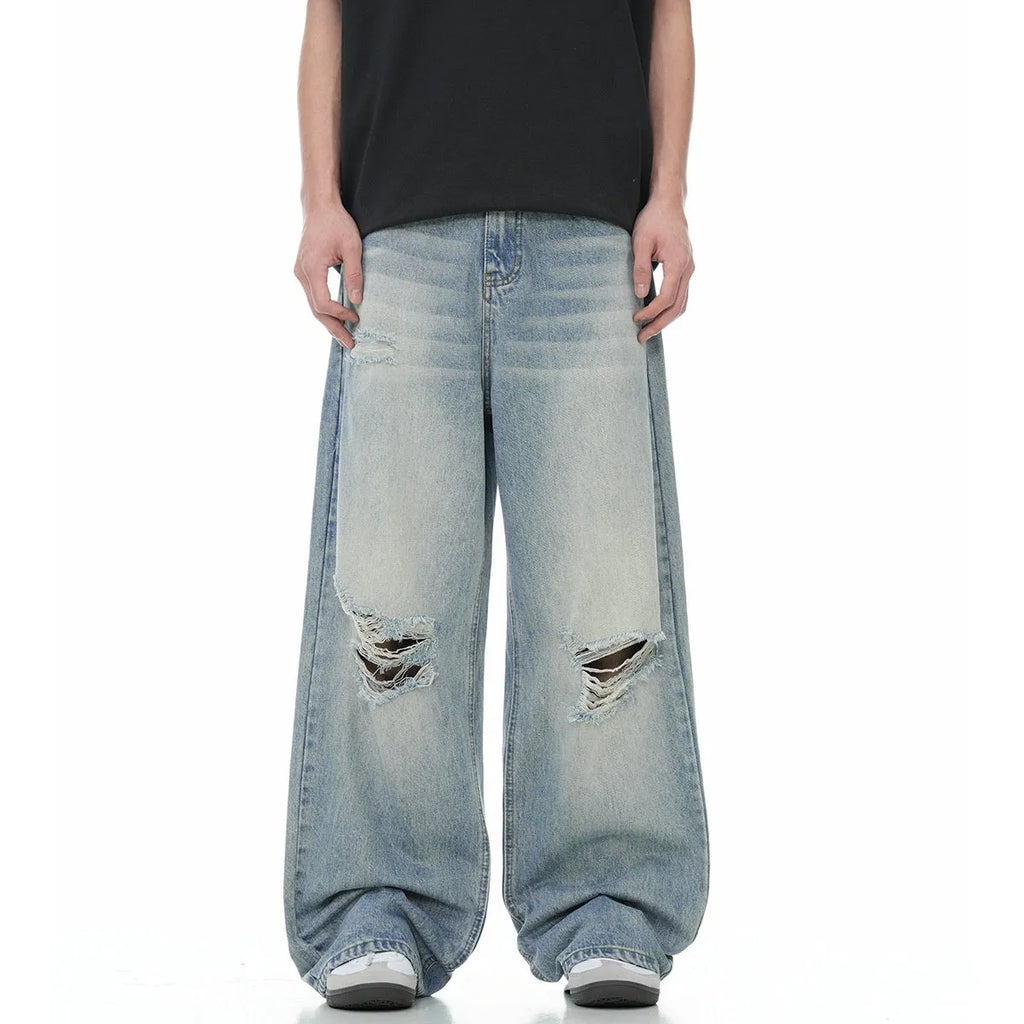 Men's blue straight-leg jeans with retro ripped distressing on the legs