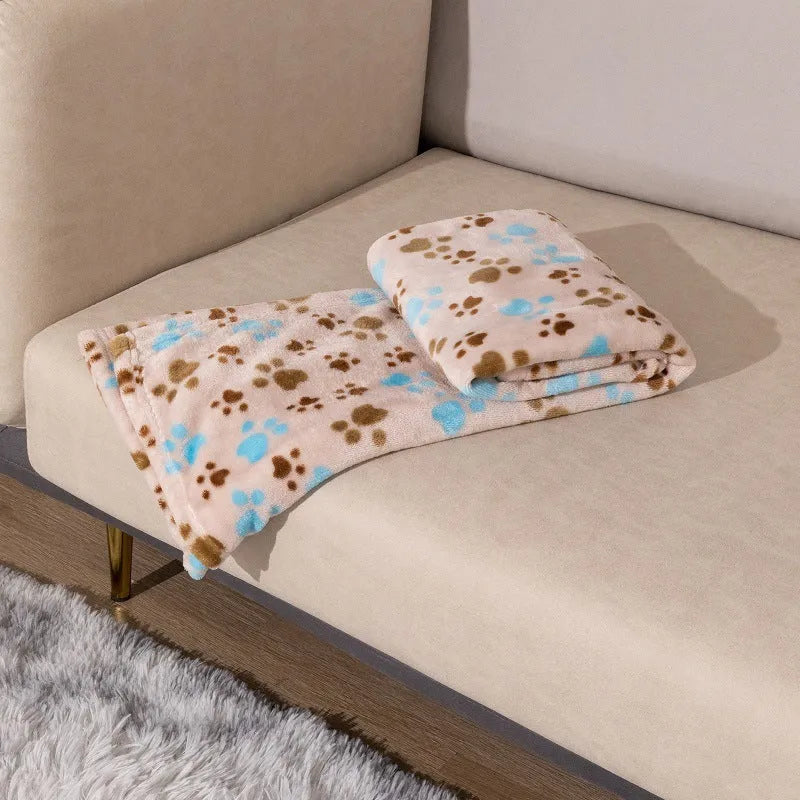 Blue cartoon dog pattern on a thick flannel pet blanket laid flat, showing its size as a dog kennel mat.