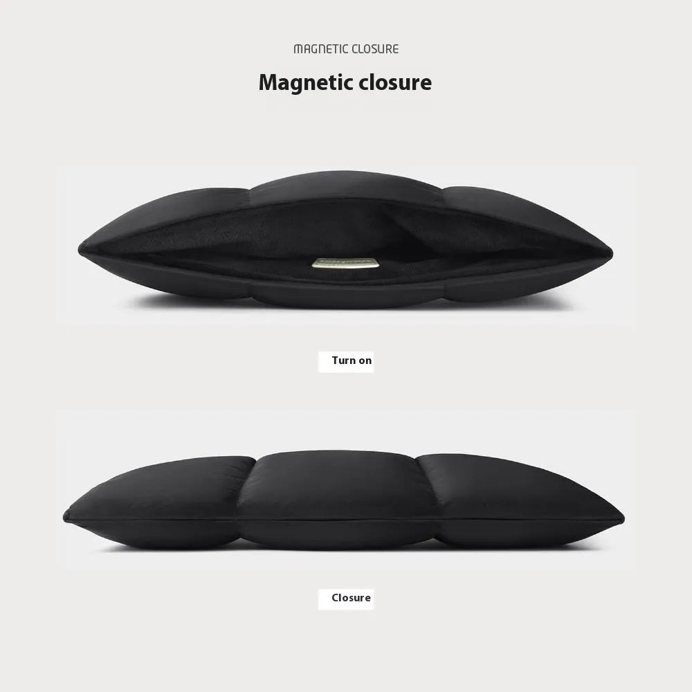 Soft fluffy black polyester laptop sleeve for a 15.6 inch laptop with visible stitching.