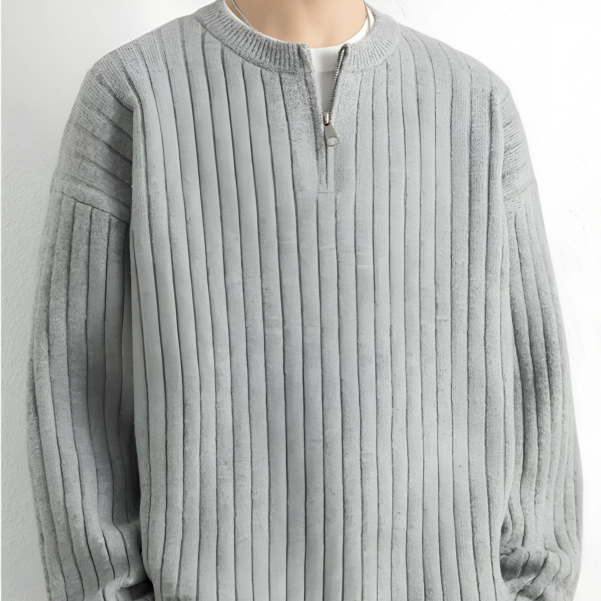 Man wearing a grey half-zip textured knit sweater, loose fit, long sleeves.
