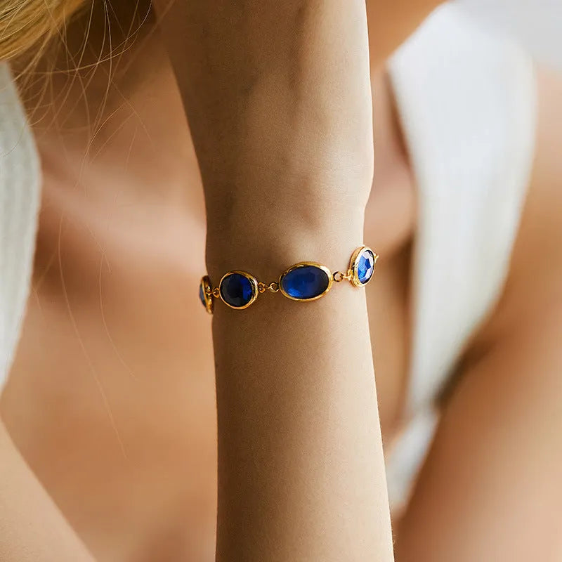 Geometric ellipse women's bracelet with blue glass inlay on an 18K copper band.
