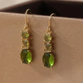 Green geometric quadrilateral copper earrings in a retro Bohemian unisex style.