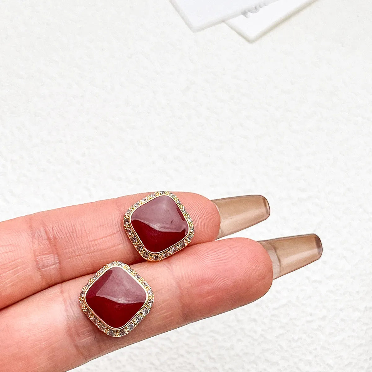 Red square-shaped alloy earrings for women with geometric design and Seiko-treated finish.