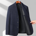Loose-fit men's woolen coat in black, shown on a model for casual spring or autumn wear.