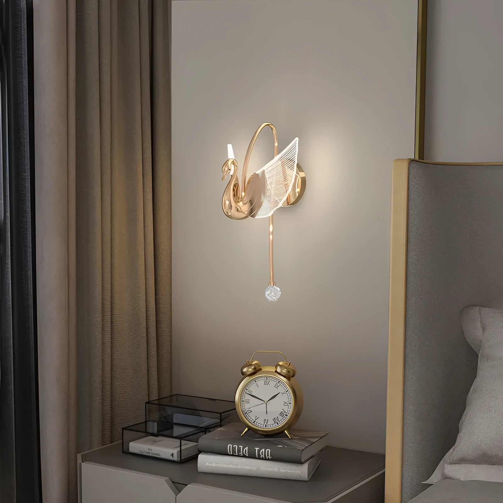 Gold modern swan wall lamp with acrylic shade mounted beside bed