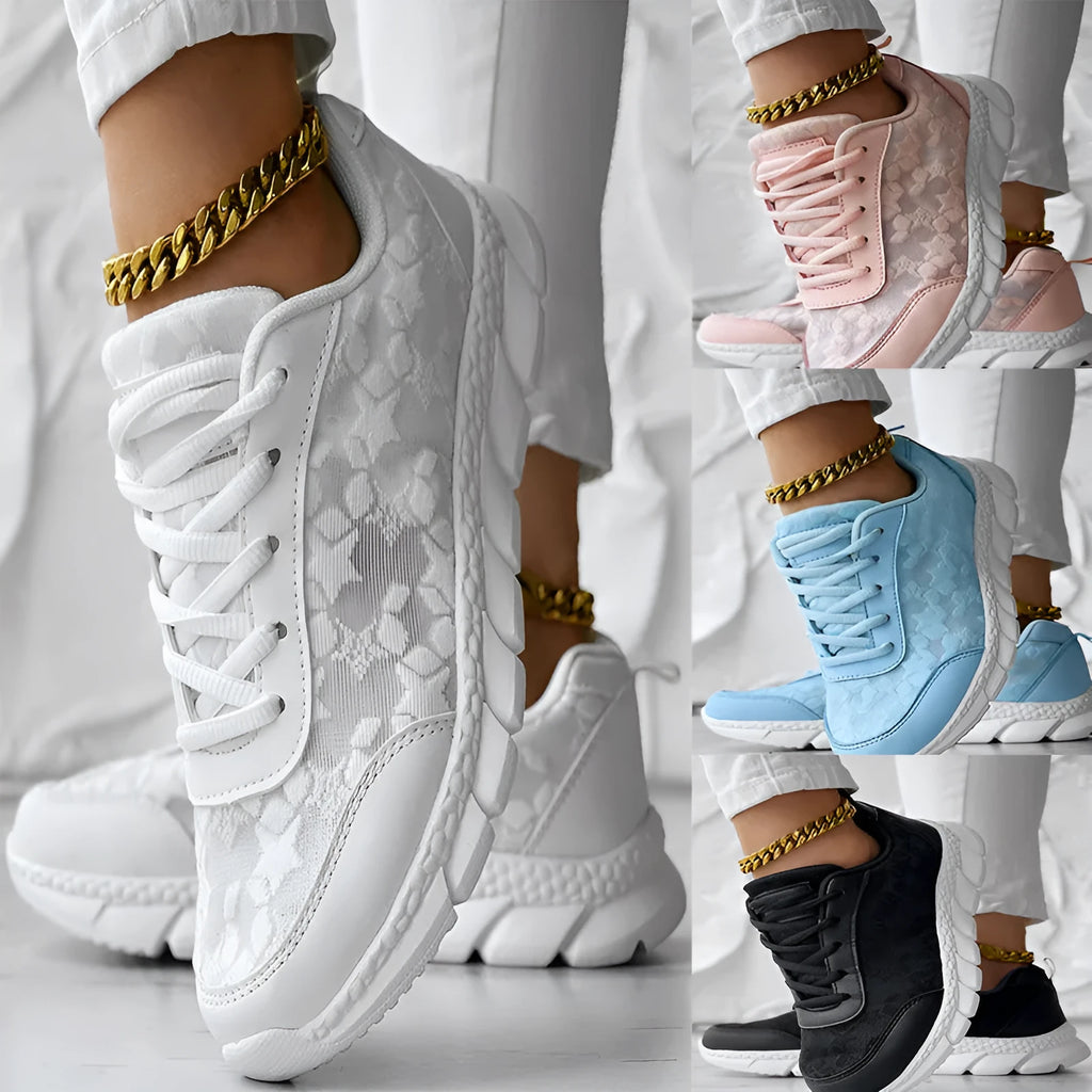 Women's white canvas sports shoes with flat heel and round toe design on neutral background