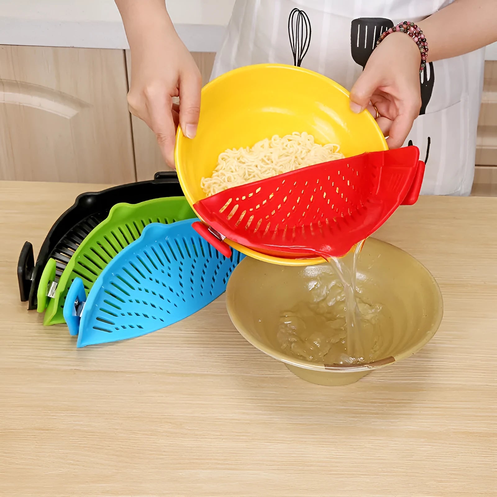 Silicone clip-on funnel colander in kitchen draining liquid from pot