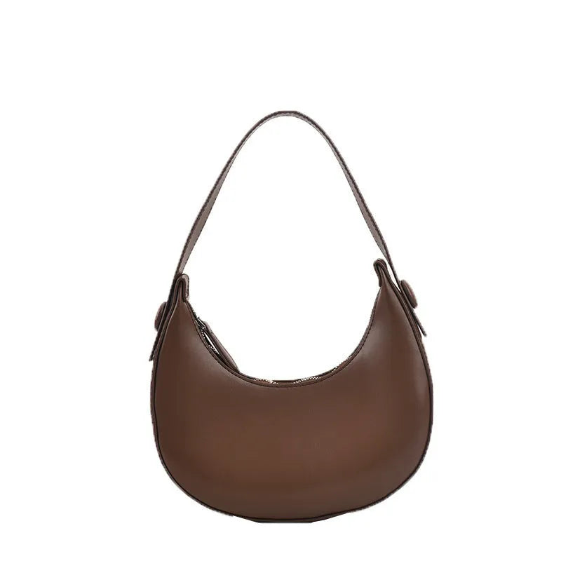 Women's retro-style dumpling-shaped PU leather shoulder bag in cream yellow, showing sandwich pocket.