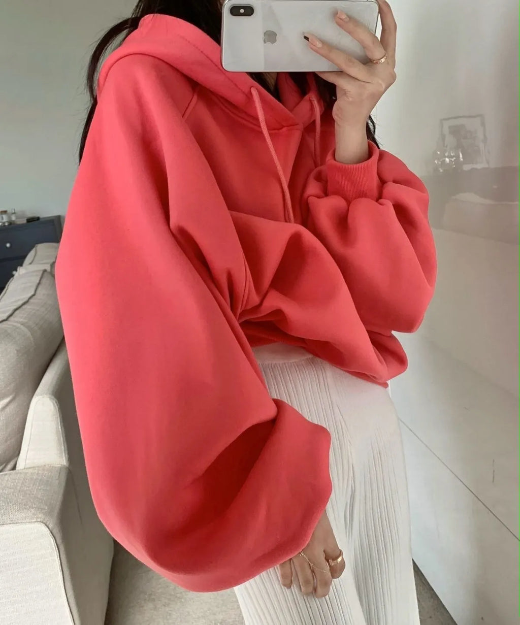 Watermelon red women's sleeveless hooded sweater made from mulberry silk fabric on a hanger.