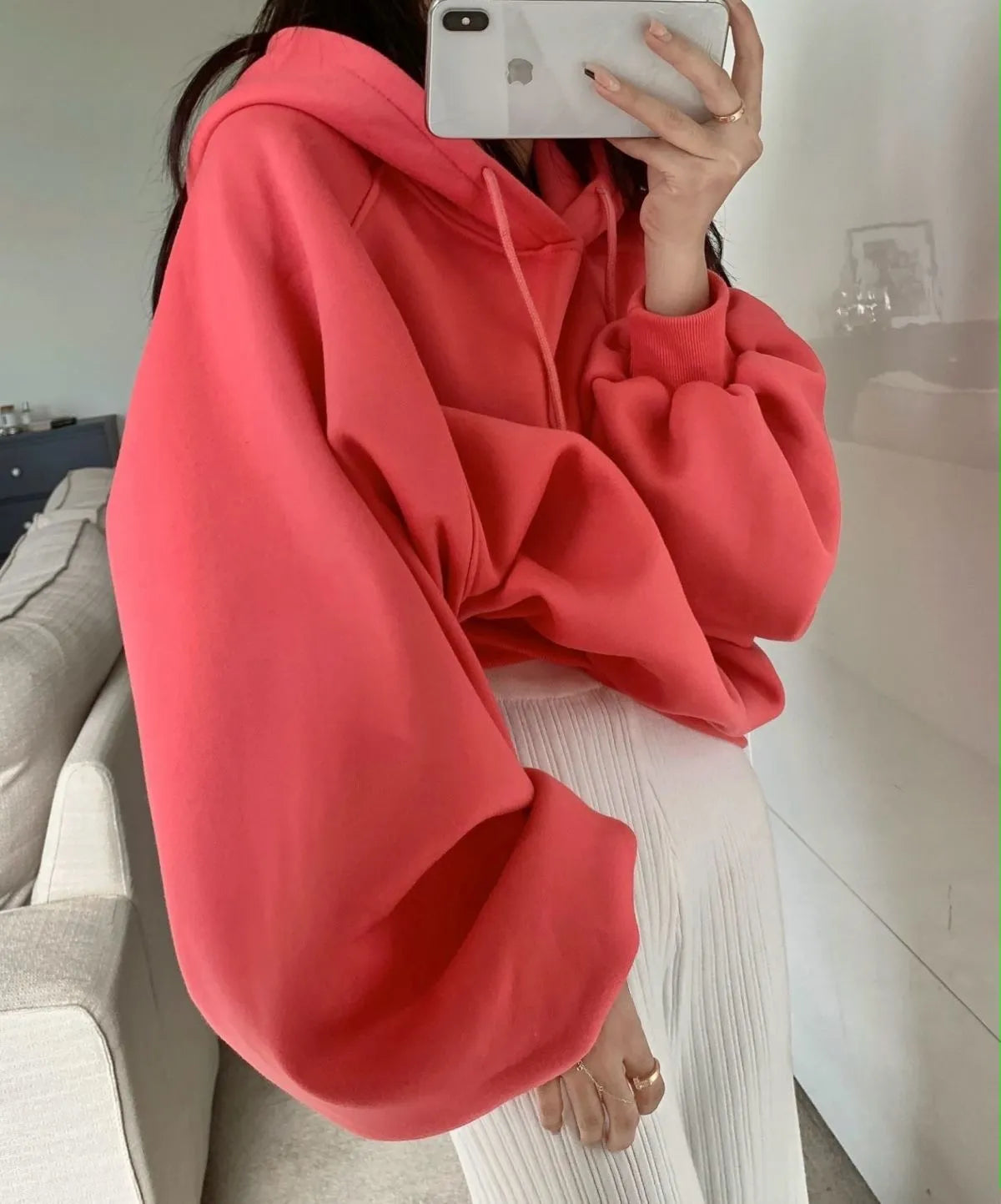 Watermelon red women's sleeveless hooded sweater made from mulberry silk fabric on a hanger.