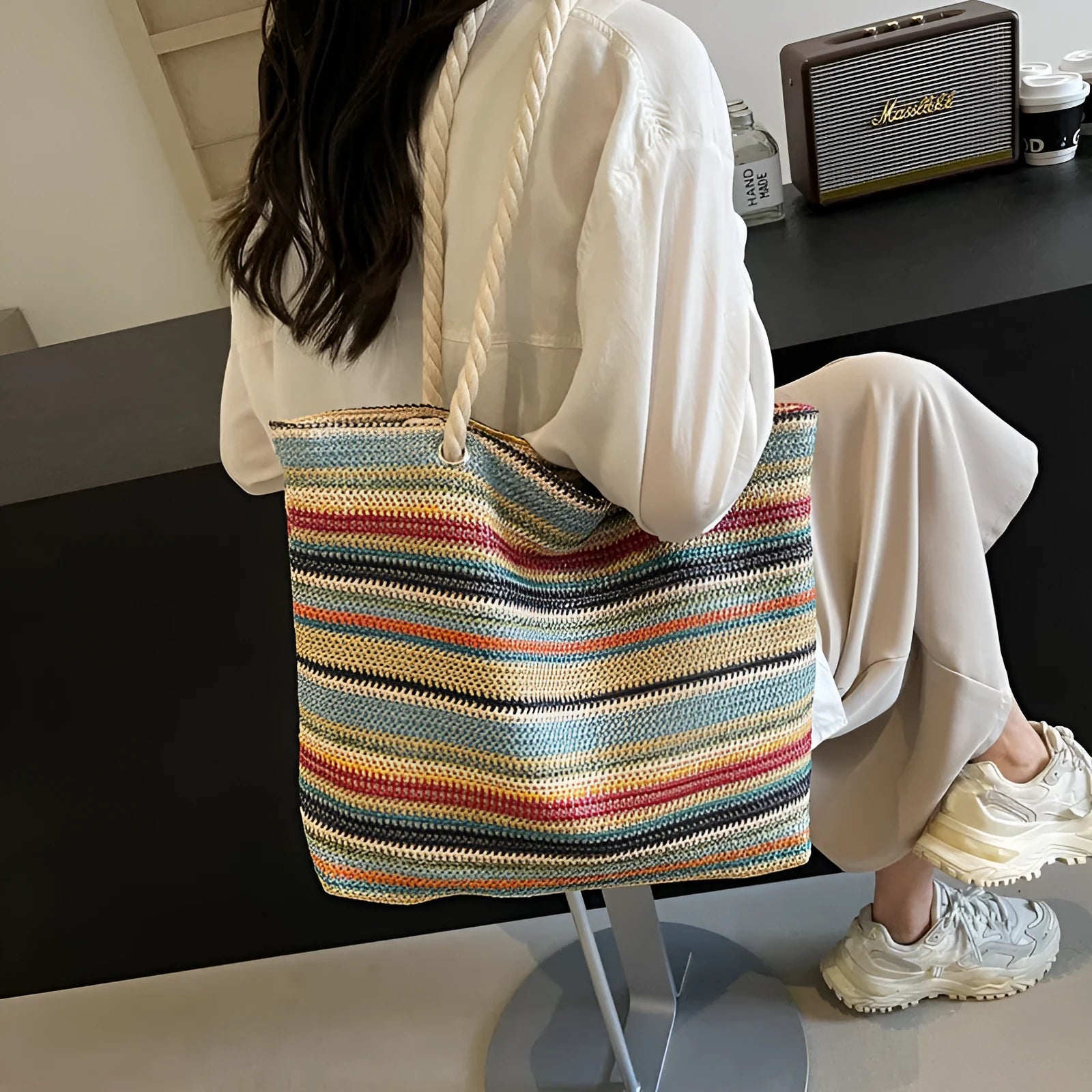 Blue straw-woven nylon shoulder bag with a single strap and large main compartment.
