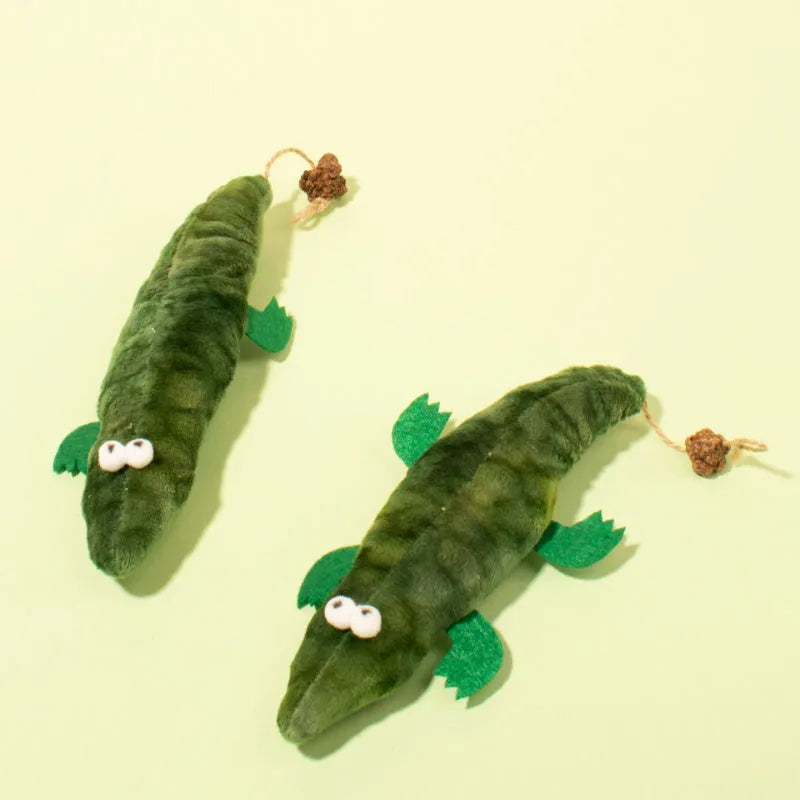 Green plush alligator catnip toy with natural peppermint scent for feline oral cleansing