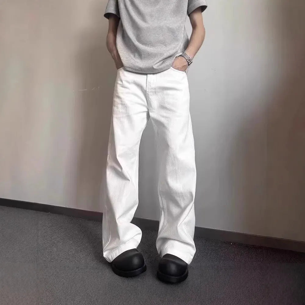 White men's straight-leg jeans with a wide loose cut on a mid waist, featuring a zipper fly.