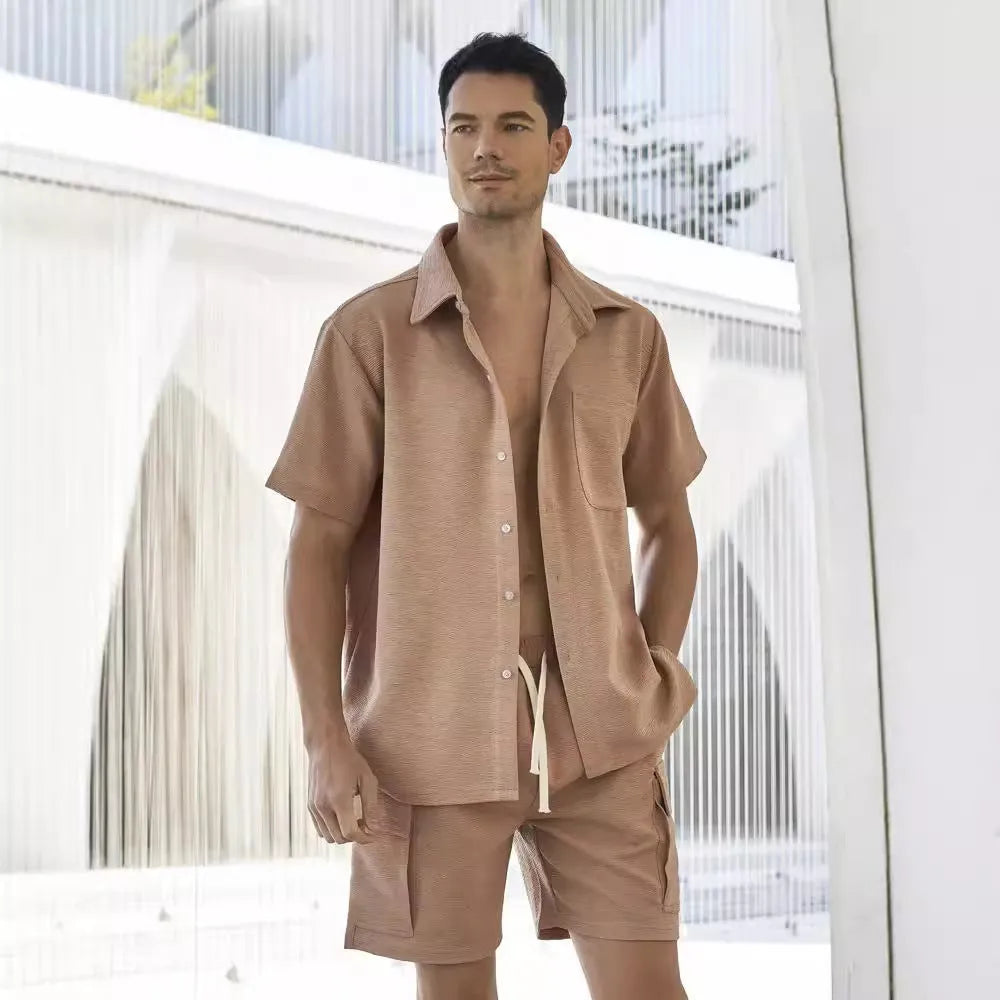 Beige polyester short-sleeve top and elastic waist shorts two-piece set laid flat.