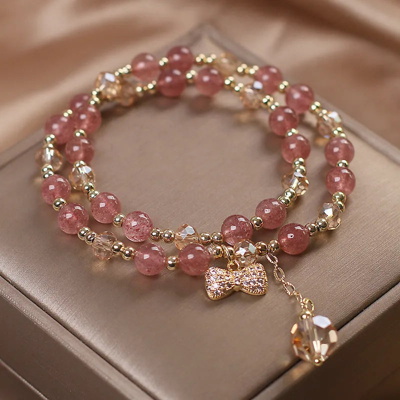 Women's double layer strawberry quartz bracelet with lucky cat charm in red cat's eye flowers colour.