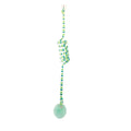 Colourful suction cup cat toy with spring wand and inflatable ball, hanging on a glass door