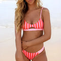 Women's black and white dot polyester bikini set laid flat, showing Asian sizes S, M, L, XL.