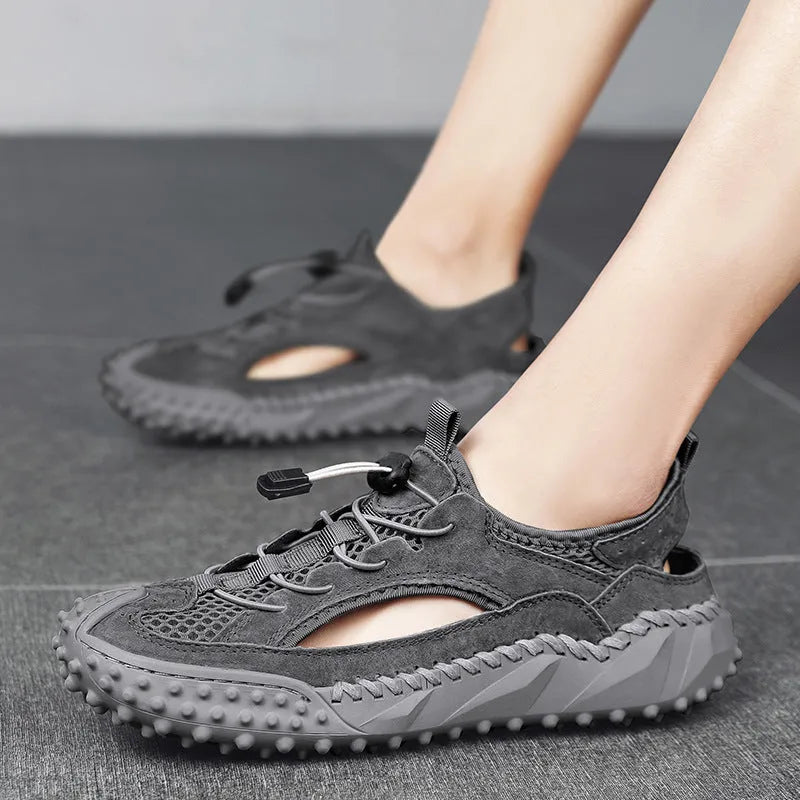 Men's black waterproof wading shoes with leather mesh upper, holes for drainage, and a rubber sole.
