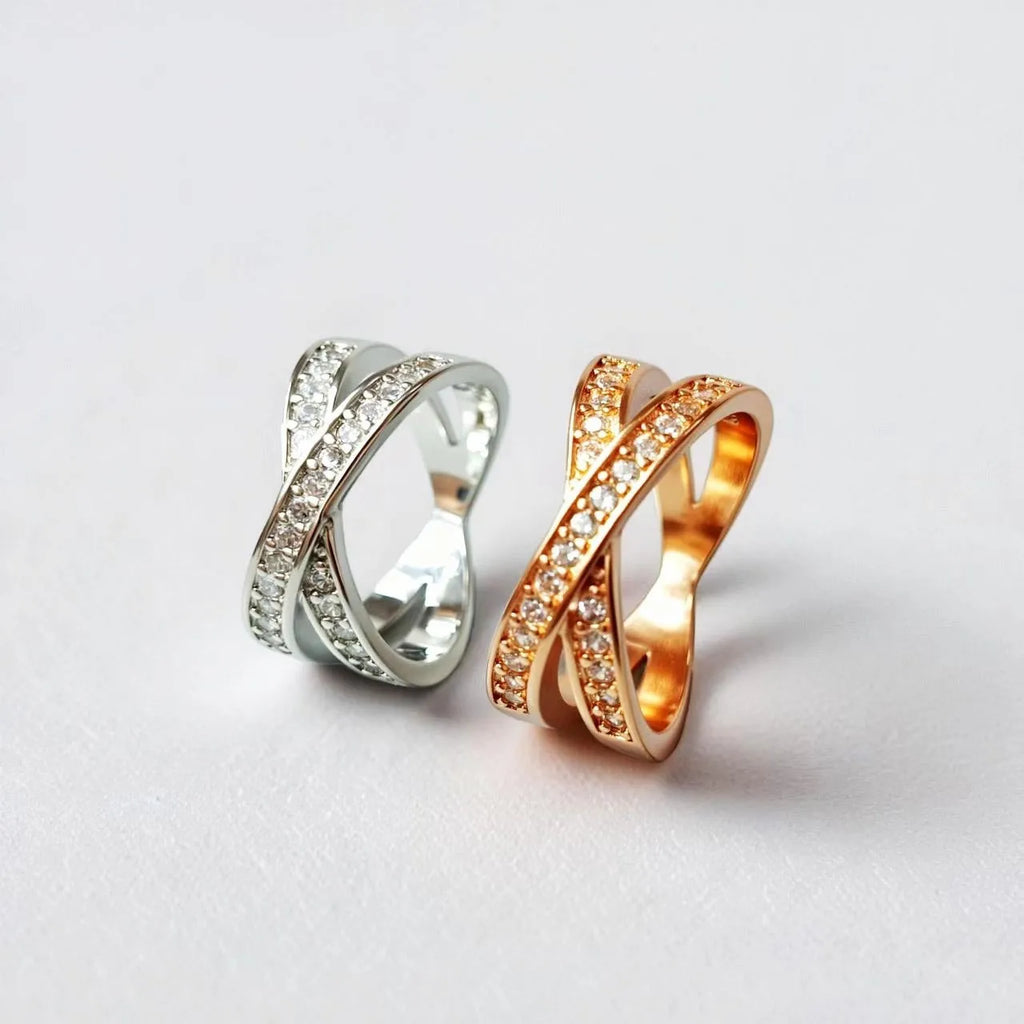 A simple copper ring with a metal cross design featuring micro-inlaid zircon, shown in rose gold and silver tone finishes.