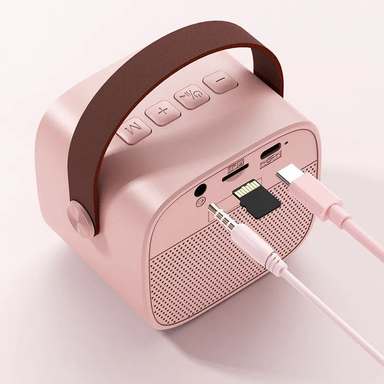 Compact portable Bluetooth speaker with microphone in white, pink, or blue plastic casing