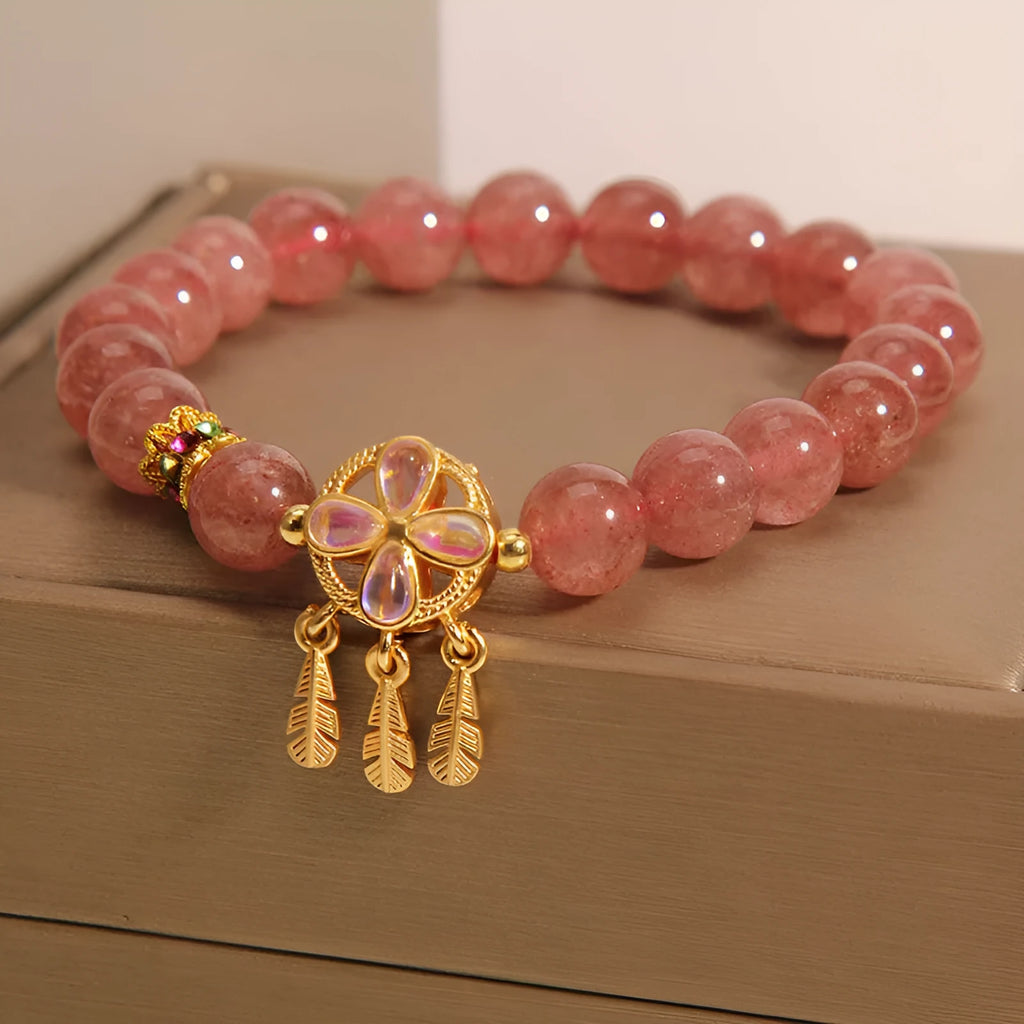 Women's bracelet with a strawberry quartz dream catcher ball pendant on a crystal chain.