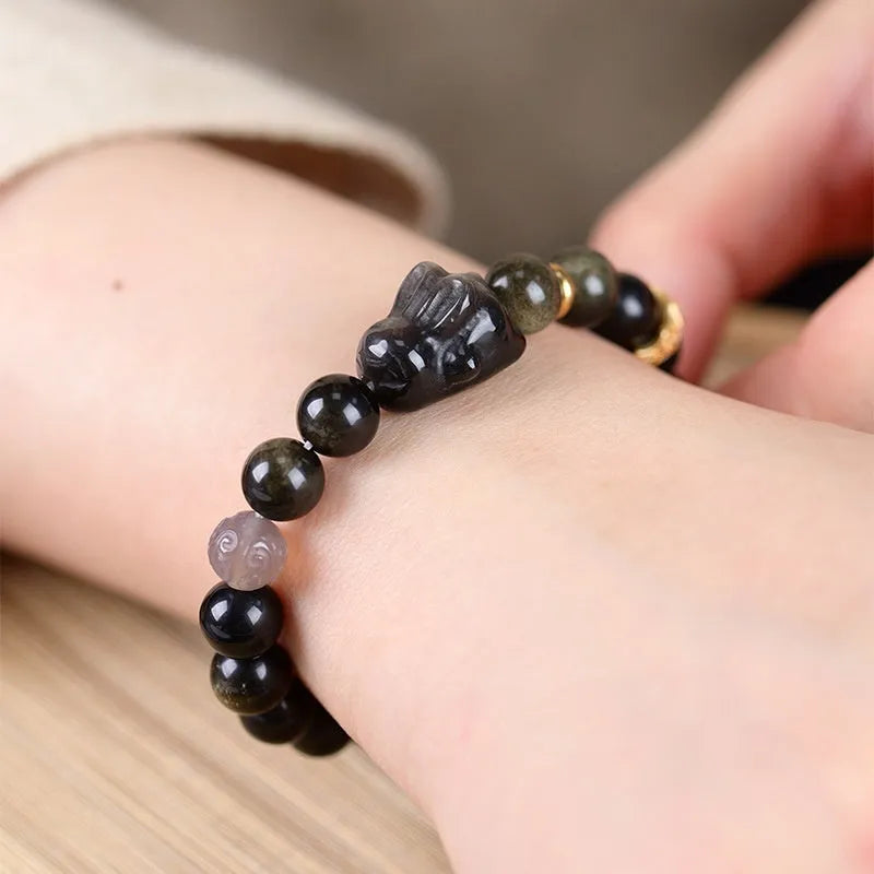 Handmade lying rabbit charm obsidian bracelet with grey agate beads in 8mm and 10mm sizes.