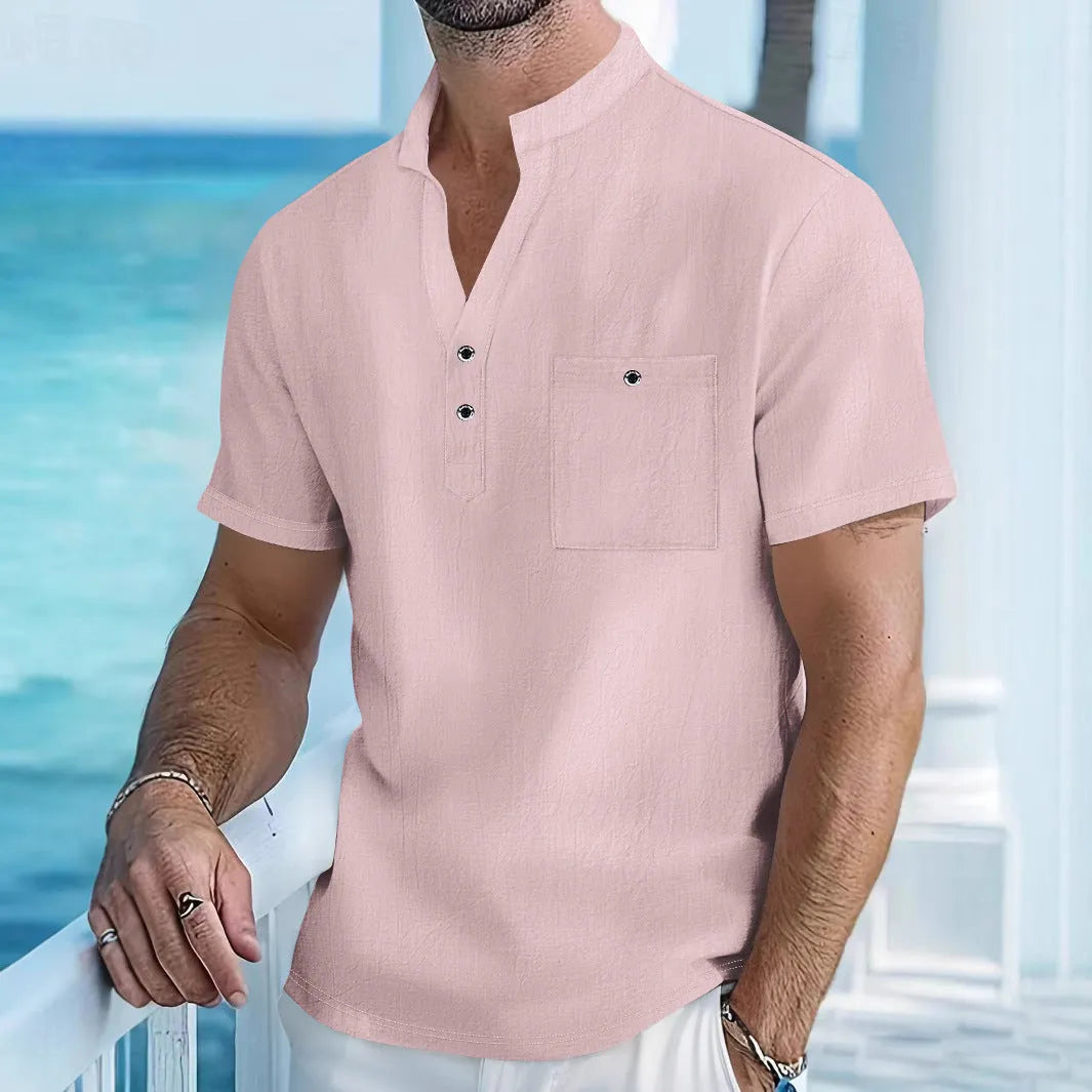 A man wearing a light-coloured linen blend stand collar t-shirt with short sleeves in a loose fit.