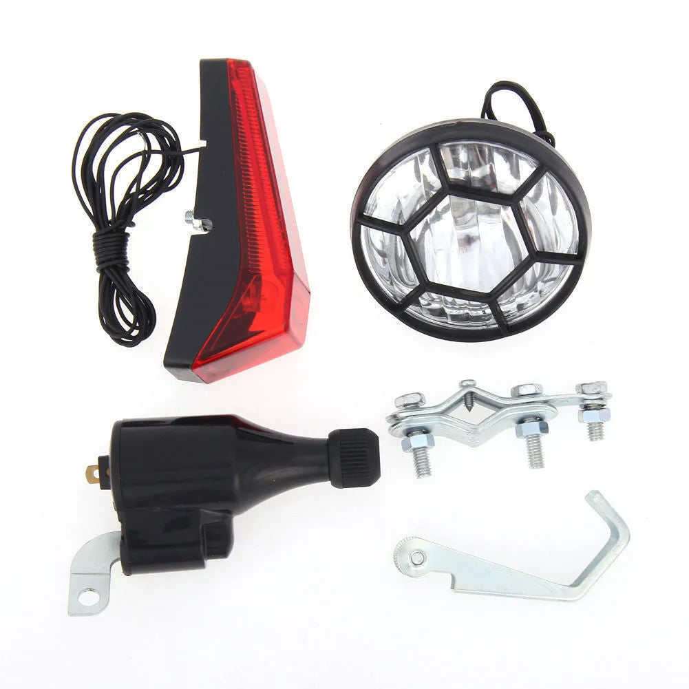 Silver bicycle dynamo light kit with generator head for friction drive mounting on bicycle frame