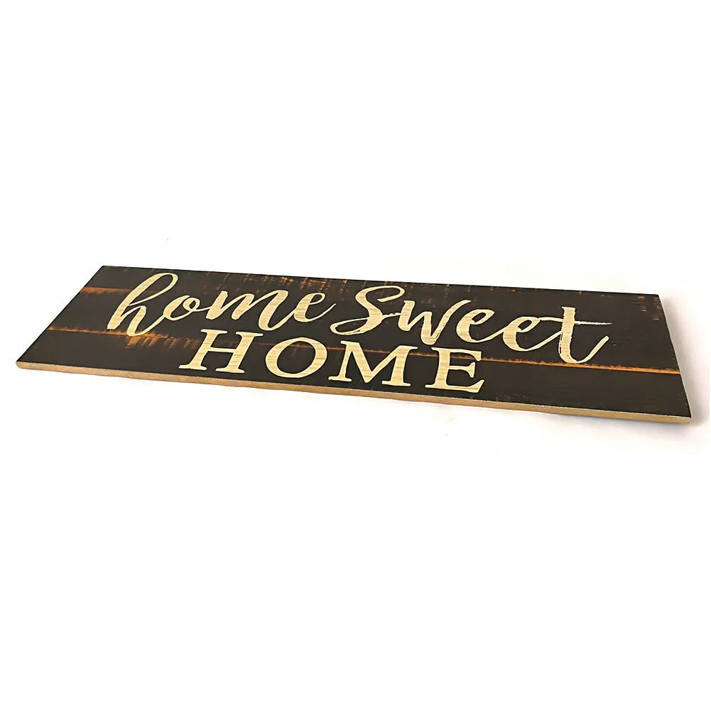 Black wooden wall plaque with carved white HOME SWEET HOME text, showing its rectangular shape.